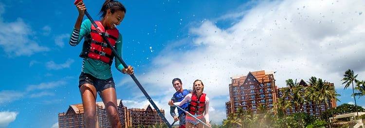Attendees paddle surfing at Disneys Aulani Resort in Hawaii