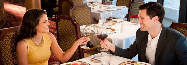 A couple makes a toast in Enchanté, a restaurant on board the Disney Wish cruise ship