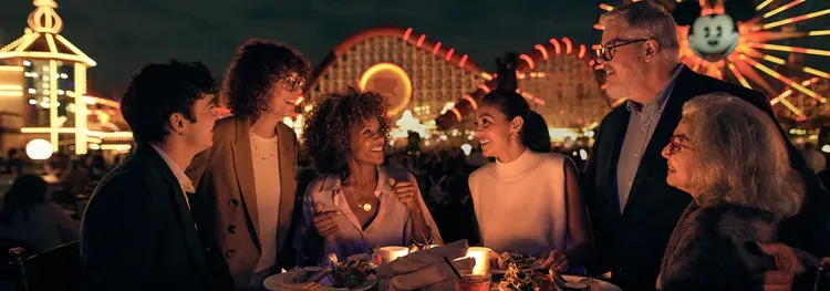 Six Guests gathered around a high dinner table in Paradise Gardens Park at Disney California Adventure Park