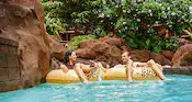 Guests floating in inner tubes at the Waikolohe Stream