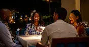 Four Guests sitting and laughing at a dining table