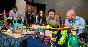 Colleagues engaging in a team building exercise that involves toys from the Disney and Pixar animated film Toy Story