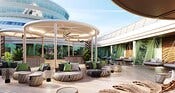 Outdoor lounge area on a Disney cruise ship with round seating, cabanas and hanging chairs under shade