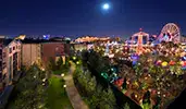 Hotel balconies overlook attractions of Disney California Adventure Park at night