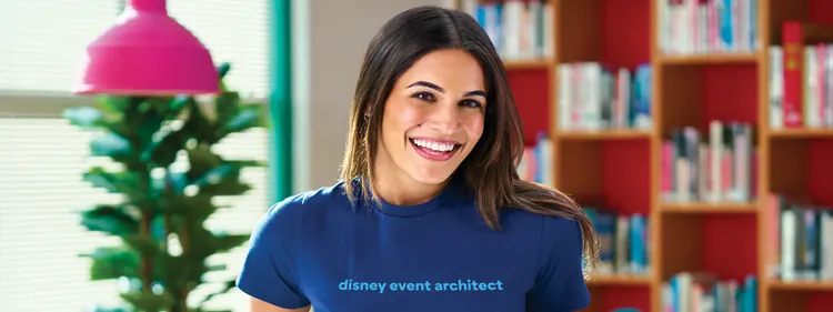 A female Disney Event Architect smiling in a disney meeting space