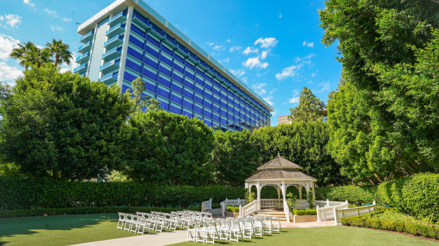 The Rose Court Garden gazebo at the Disneyland Hotel, with rows of chairs in front of the gazebo and lush foliage around it