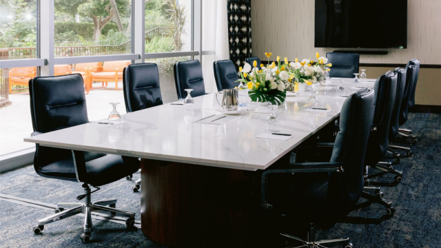 A private boardroom with a large marble conference table and garden views at Disneyland Hotel