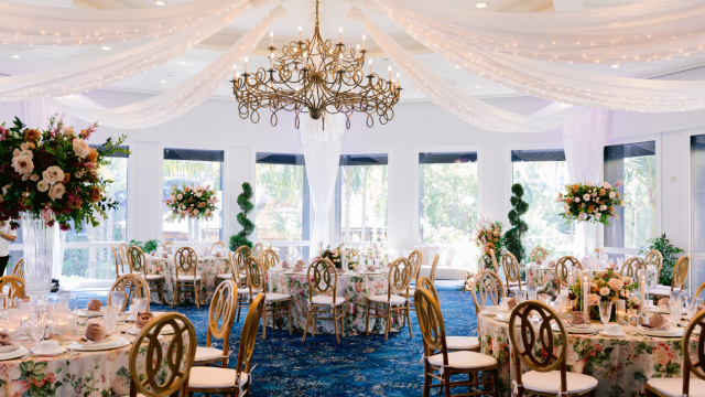 Tables set with exquisite tableware and flower arrangements at the elegant Sleeping Beauty Pavilion in the Disneyland Hotel