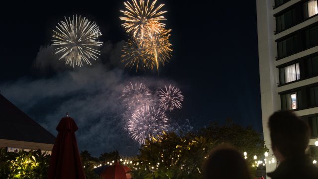 Guests watching fireworks light up the sky near Pixar Place Hotel