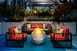 Deck furniture surrounding an outdoor firepit that looks like Jack Jack from 'The Incredibles'
