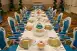 A set table topped with dessert trays containing macarons and cake