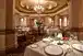 A spacious restaurant dining room with elegant tables and settings