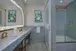 Suite bathroom with a double sink, a large mirror and a bathtub at Disney's Grand Floridian Resort & Spa