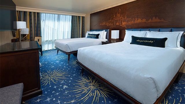 A hotel room at Disneyland Hotel with 2 beds and a large window