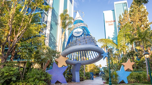 A wizard hat structure with stars and a sign that reads Disneyland Hotel